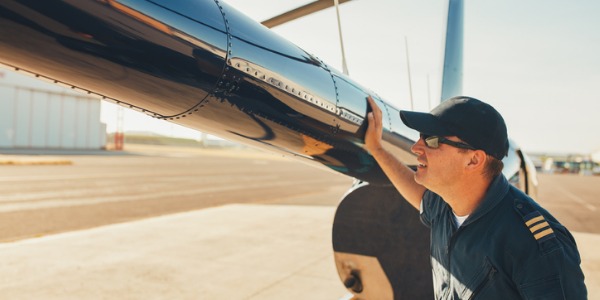 An aviation inspector conducting a preflight inspection to ensure the safety of the aircraft.