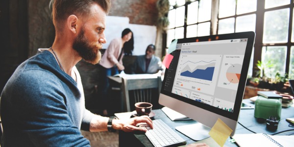 A data scientist sitting at his desk, collecting and interpreting data.