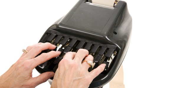 An image of a court reporter typing on a steno machine.